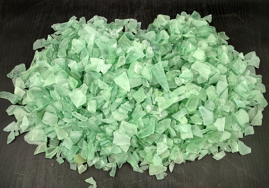 Photo of 10 pound pile of bottle green sea glass. Copyright 2024 Seashellsupply.com.