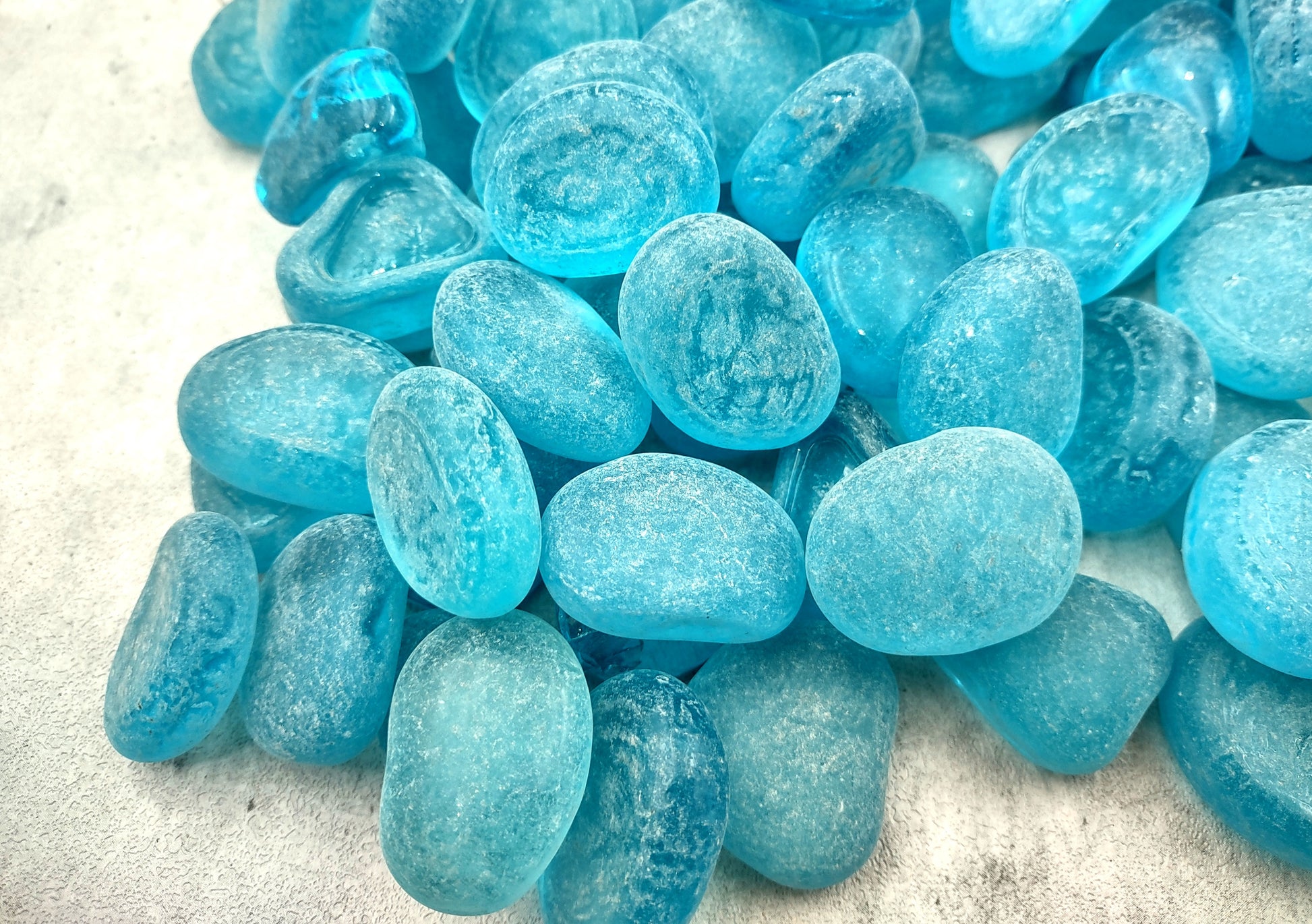 Beach Sea Glass Rounded Turquoise Blue Frosted Tumbled Pebbles (approx. 1 Kilogram or 2.2 lbs. 1-1.5 inch). Pile of blue turquoise Beach Glass pebbles. Copyright 2024 SeaShellSupply.com.