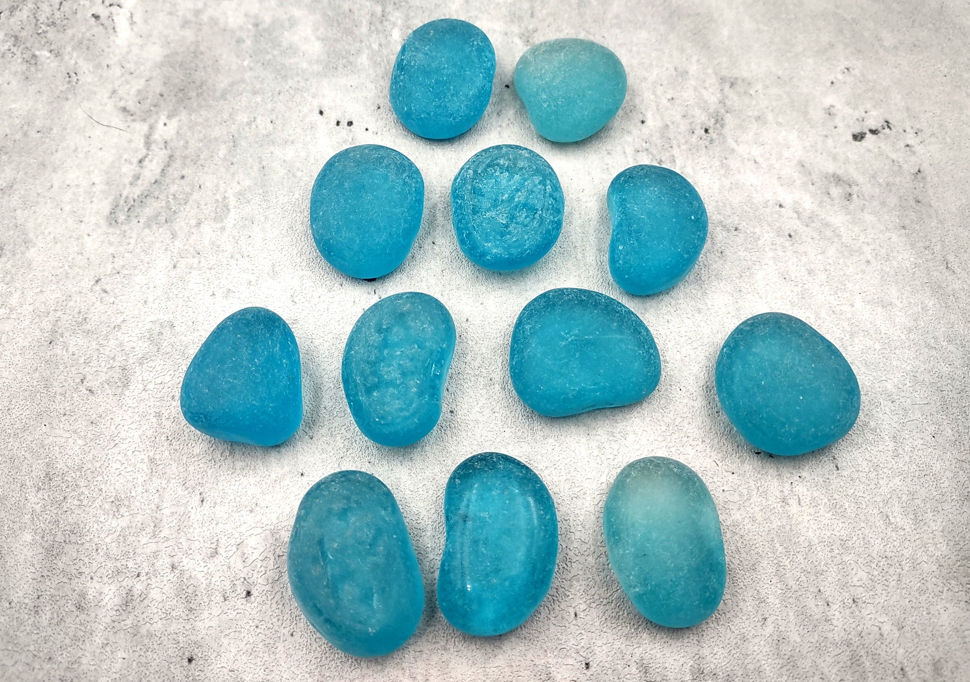 Beach Sea Glass Rounded Turquoise Blue Frosted Tumbled Pebbles (approx. 1 Kilogram or 2.2 lbs. 1-1.5 inch). Pile of blue turquoise Beach Glass pebbles. Copyright 2024 SeaShellSupply.com.