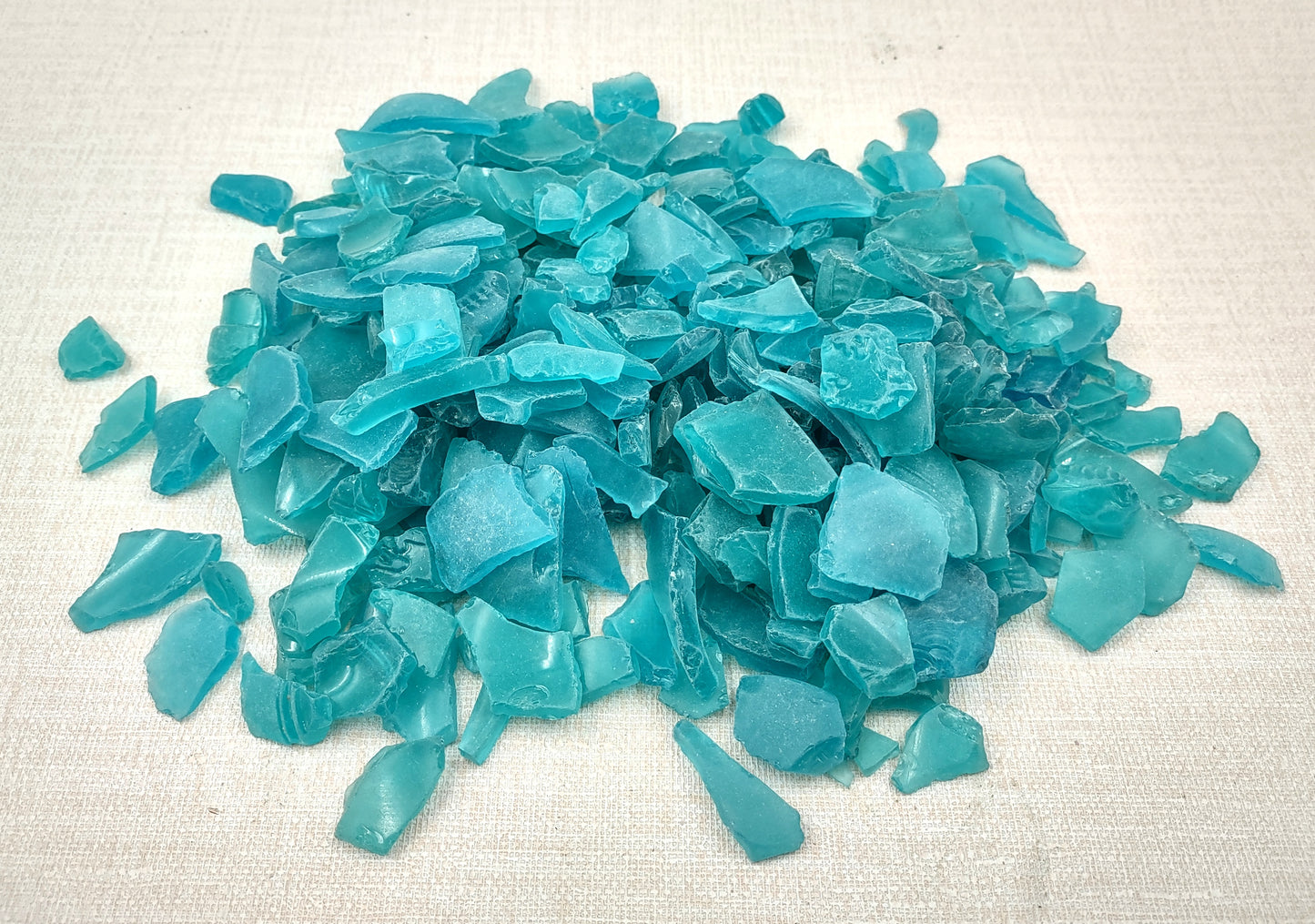 Beach Sea Glass Rough Ocean Blue Frosted (approx. 1 kilogram 0.5-1+ inches) Man made tumbled frosted sea glass fragments. Copyright 2024 Seashellsupply.com