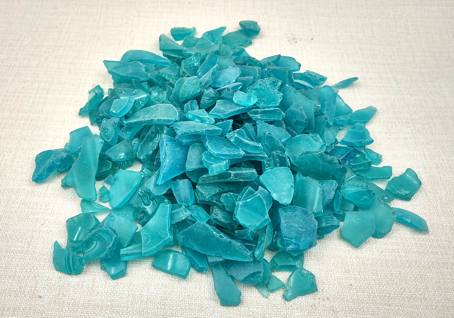 Beach Sea Glass Rough Ocean Blue Frosted (approx. 1 kilogram 0.5-1+ inches) Man made tumbled frosted sea glass fragments. Copyright 2024 Seashellsupply.com