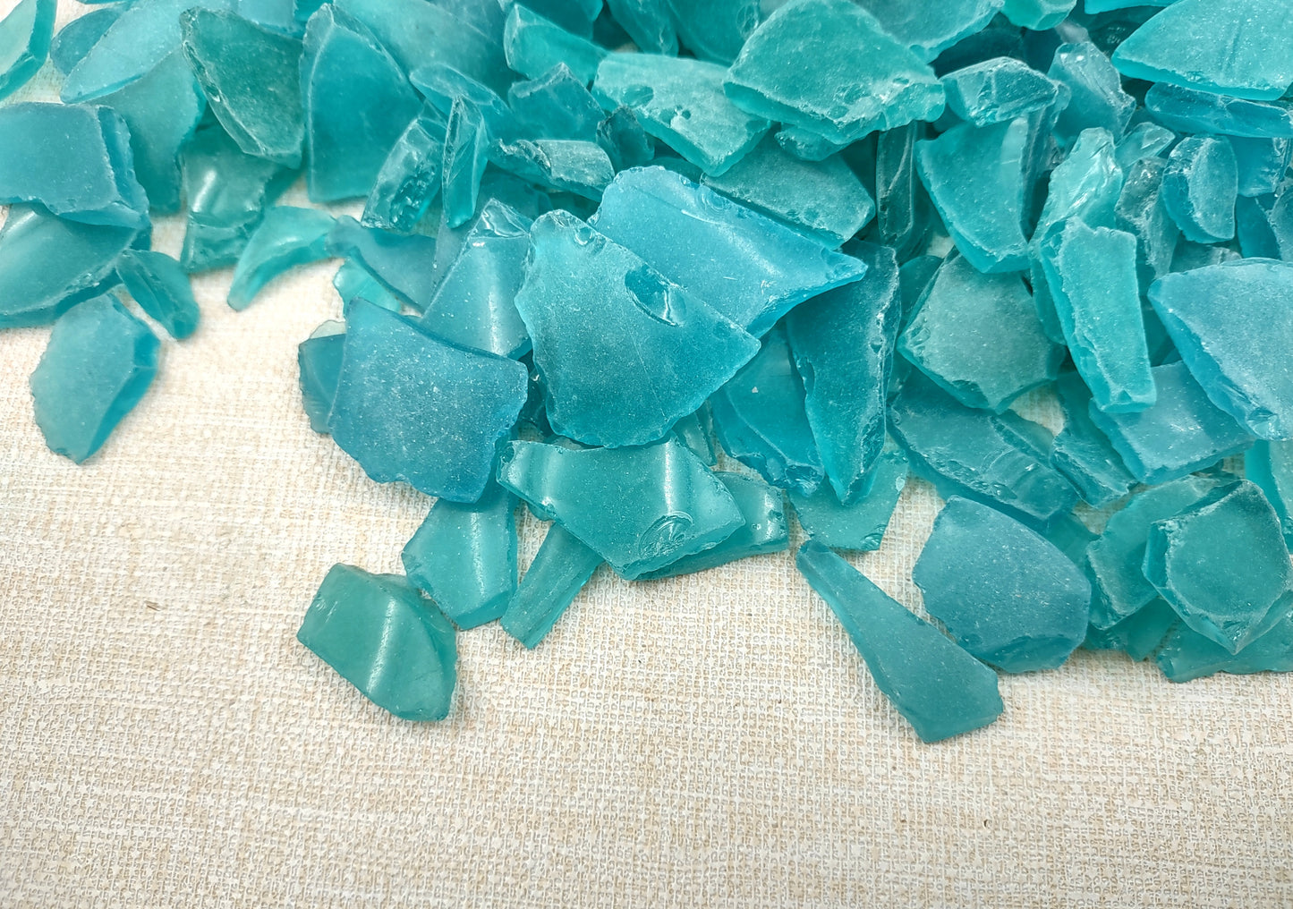 Beach Sea Glass Rough Ocean Blue Frosted (approx. 1 kilogram 0.5-1+ inches) Man made tumbled frosted sea glass fragments. Copyright 2024 Seashellsupply.com