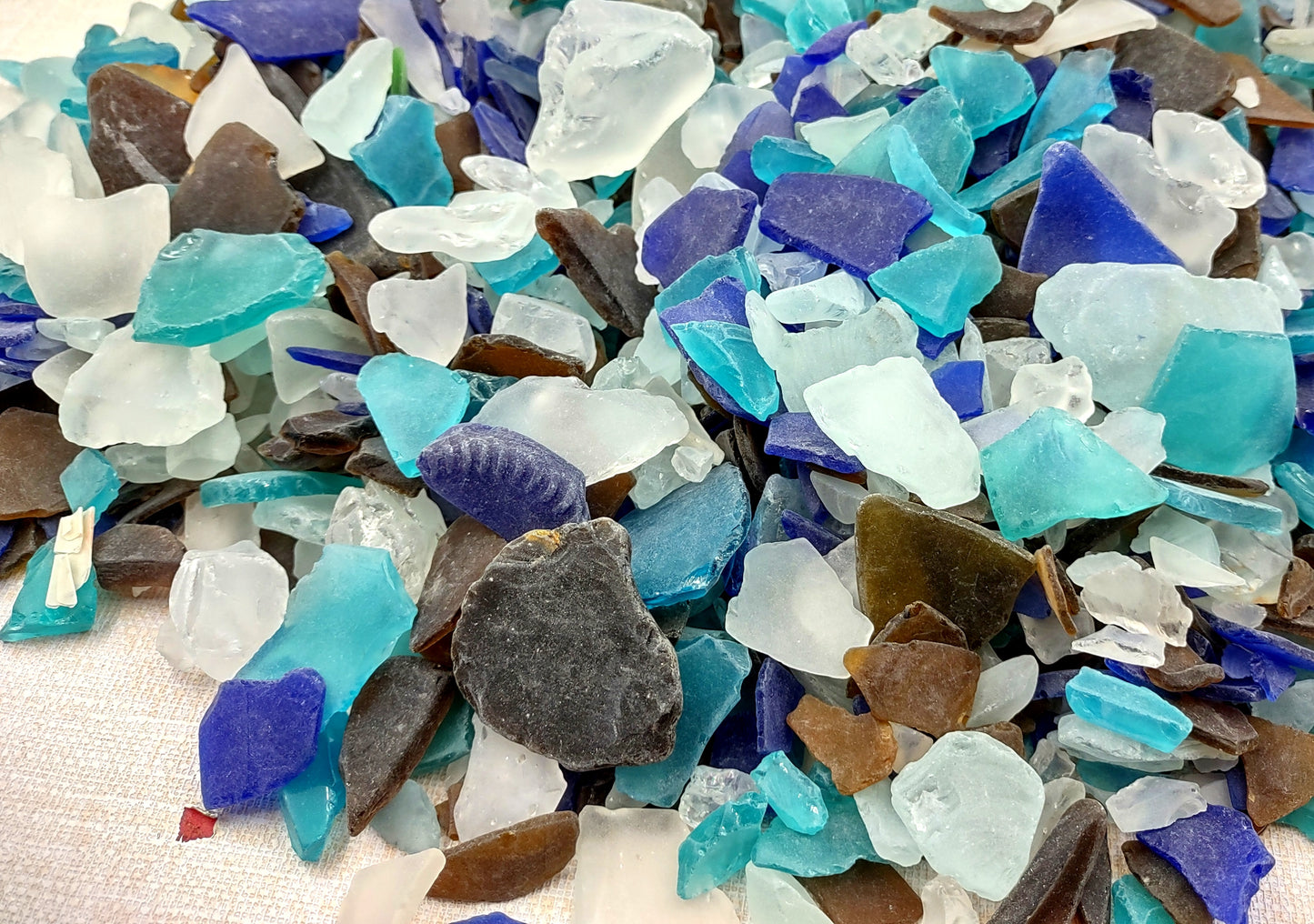 Beach Sea Glass Rough Pacific Mix Medium Tumbled (approx. 10 pounds 0.5-1+ inches) Man made tumbled rough sea glass fragments. Copyright 2024 seashellsupply.com