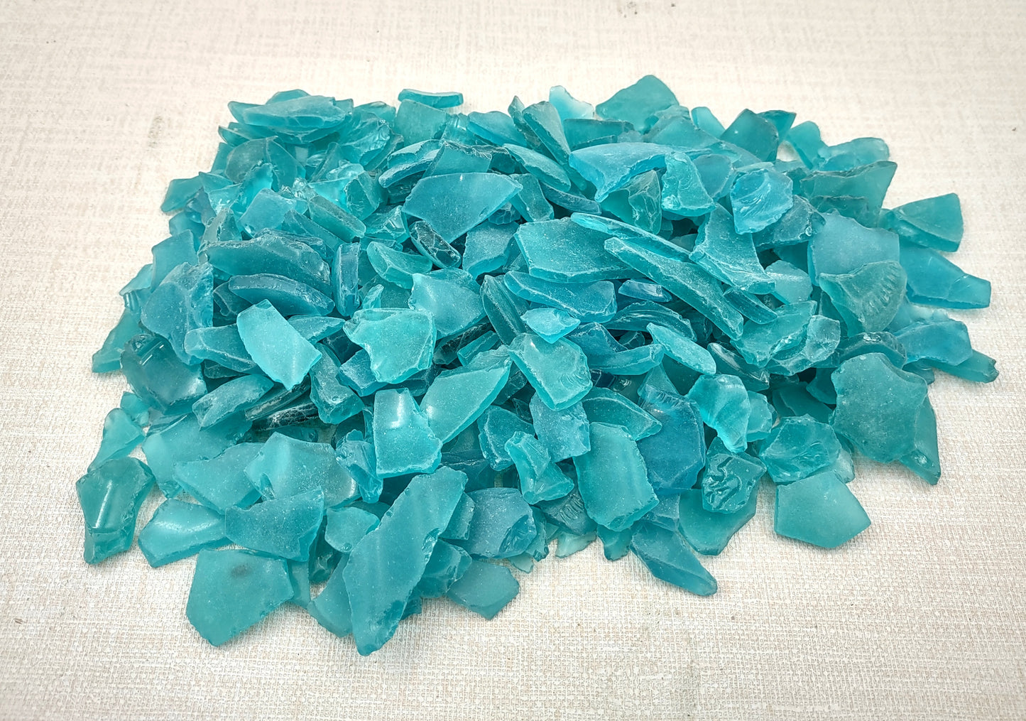 Beach Sea Glass Rough Ocean Blue Frosted (approx. 1 kilogram 0.5-1+ inches) Man made tumbled frosted sea glass fragments. Copyright 2024 Seashellsupply.com