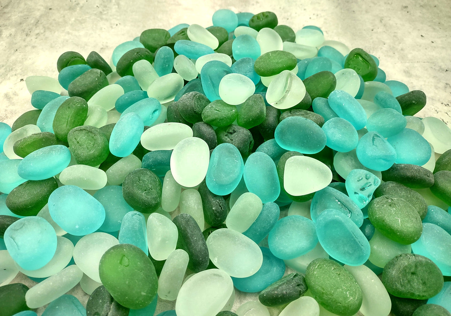 Beach Sea Glass Rounded White Blue Green Assorted Tumbled Pebbles (approx. 10 pounds 1+ inch) Copyright 2024 SeaglassSupply.com